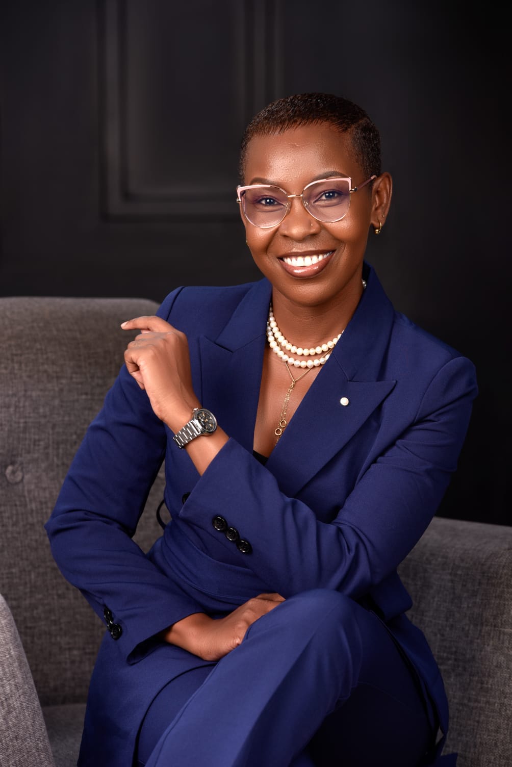 Eunice Ireri in a navy suit, seated